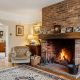 A certified professional from Webb & Son, your trusted local chimney sweep in Wolverhampton, performing routine maintenance on a residential fireplace.